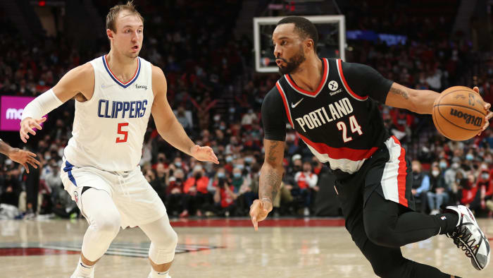 Portland Trail Blazers forward Norman Powell (24) drives on LA Clippers guard Luke Kennard (5) in the second half at Moda Center.